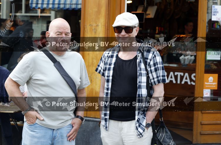 Amsterdam 17 augustus 2026
De stoet met Peter faber rijdt onder politiebegeleiding over de Haarlemmerstraat langs zijn favoriete cafe\'s . Vele mensen bewijzen hem een laatste eer. Arie Cupe met partner
