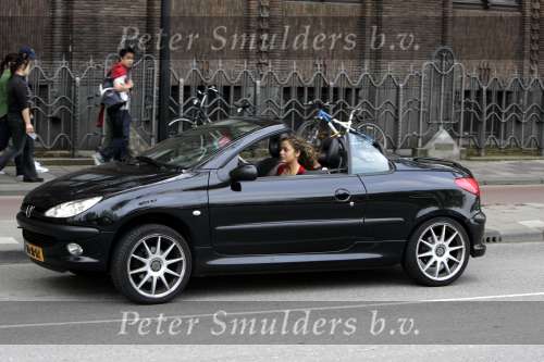 Amsterdam 28 april 2004
Fajah Lourens in haar Peugeot 206 cabrio samen met haar dochtertje.