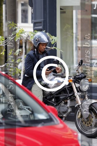 Amsterdam 14 augustus 2015  
Edgar Davids op zijn old timer motor in amsterdam zuid. Motor heeft de naam Pitbull