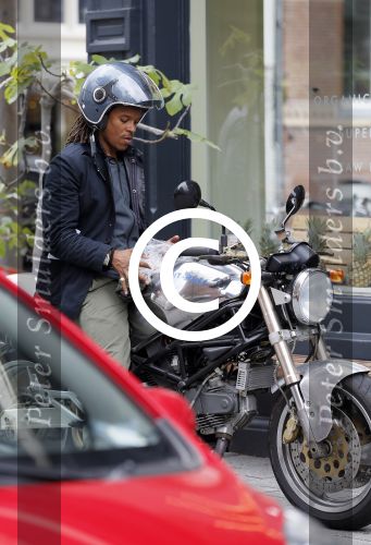 Amsterdam 14 augustus 2015  
Edgar Davids op zijn old timer motor in amsterdam zuid. Motor heeft de naam Pitbull