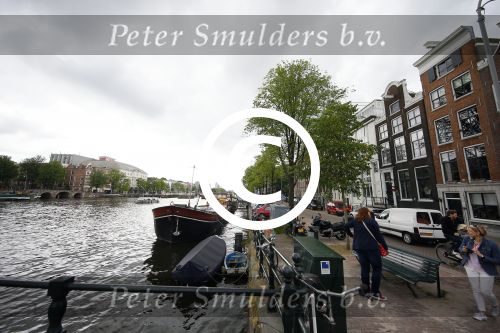 Amsterdam 20 juni 2015  
Trijntje Oosterhuis met zoontje op de fiets in Amsterdam. Trijntje gaat een huis binnen en ze geeft een toerist uitleg over hoe waar naartoe te lopen.