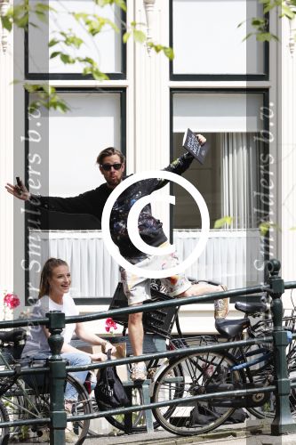 Amsterdam 13 juli 2016  
Selwyn Senatori zit samen met zijn vriendin op bankje zijn boek te signeren als haar fiets omvalt en haarvtas met mobieltje etc het water in valt . Een rondvaartboot vist alles eruit