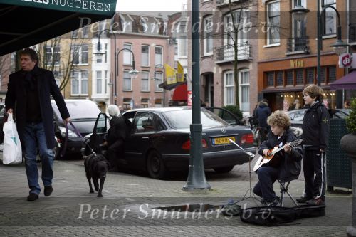 Amsterdam 27 januari 2007
Robert ten Brink met hond het winkelen op de cornelis schuytstraat. jonge straat musikant