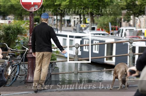 Amsterdam 5 juni 2025
Thijs Romer met petje op laat zijn hond uit in het centrum van Amsterdam.
