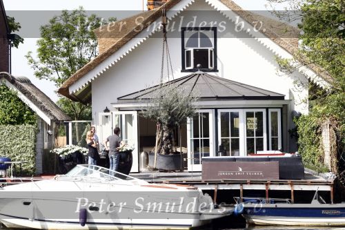 Breukelen 10 mei 2009
Jurgen Smit verrast op moederdag zijn vriendin Milika Peterzon met een 600 jaar oude olijfboom voor in hun nieuwe tuin. De boom moest met een kraanwagen over het huis getild worden.
Peter Smulders bv