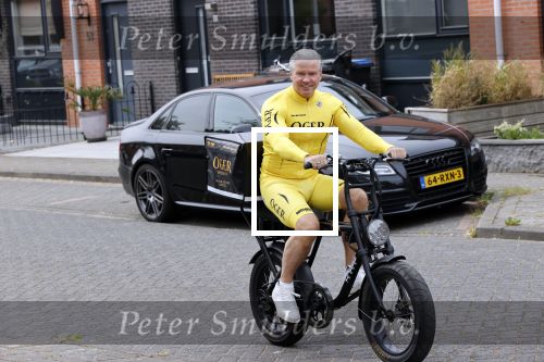 Purmerend 16 mei 2020
Dries Roelvink brengt op de fiets in een gele wielrentrui/broek een pakketje van OGER naar Danny de Munk die thuyis de deur opent als dries aan belt .