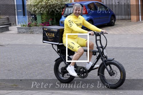 Purmerend 16 mei 2020
Dries Roelvink brengt op de fiets in een gele wielrentrui/broek een pakketje van OGER naar Danny de Munk die thuyis de deur opent als dries aan belt .