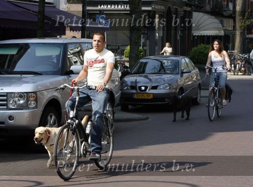 Amsterdam 16 april 2007
John  Heitinga met vriendin en honden op de fiets op de cornelis schuytstraat.