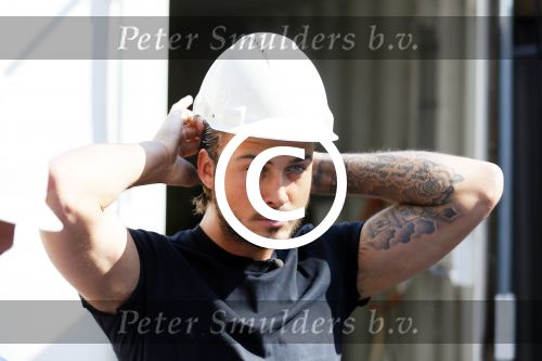 Amsterdam 15 april 2015
Dave en Dries Roelvink metselen een steen met daarop hun naam in de Westertoren. Dave heeft een tatoo van de westertoren op zijn arm staan.