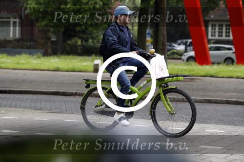 Amsterdam 13 mei 2017  
Marc Marie Huijbregts op zijn froene fiets in Amsterdam.