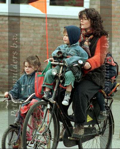 Diewertje Blok met haar kinderen fietsend door Amsterdam