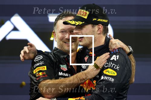 ABU DHABI, UNITED ARAB EMIRATES - DECEMBER 12: Race winner and 2021 F1 World Drivers Champion Max Verstappen of Netherlands and Red Bull Racing celebrates with Red Bull Racing Team Principal Christian Horner on the podium during the F1 Grand Prix of Abu Dhabi at Yas Marina Circuit on December 12, 2021 in Abu Dhabi, United Arab Emirates. (Photo by Bryn Lennon/Getty Images)