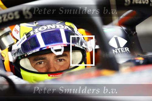 ABU DHABI, UNITED ARAB EMIRATES - DECEMBER 15: Sergio Perez of Mexico and Red Bull Racing prepares to drive in the garage during Formula 1 testing at Yas Marina Circuit on December 15, 2021 in Abu Dhabi, United Arab Emirates. (Photo by Clive Rose/Getty Images)