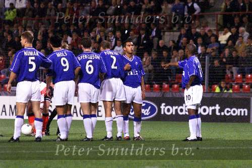 Eindhoven, 28 September 1999
Wedstrijd uit de voorronde van de CHAMPIONS-League tussen PSV & Glasgow Rangers, eindstand 0-1
Met de drie nederlanders in schotse dienst met v.l.n.r.: Arthur Numan, Michael Mols en Giovanni v Bronckhorst