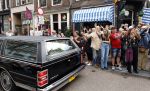 Amsterdam 17 augustus 2026
De stoet met Peter faber rijdt onder politiebegeleiding over de Haarlemmerstraat langs zijn favoriete cafe's . Vele mensen bewijzen hem een laatste eer.