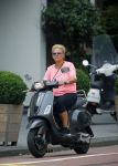 Amsterdam 10 augustus 2015
Caroline Tensen op haar Vespa scooter rijdend door Amsterdam