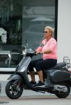 Amsterdam 10 augustus 2015
Caroline Tensen op haar Vespa scooter rijdend door Amsterdam