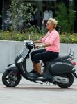 Amsterdam 10 augustus 2015
Caroline Tensen op haar Vespa scooter rijdend door Amsterdam
