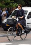 Amsterdam 12 augustus 2015 
Susan Visser met hondje op de fiets.