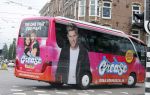 Amsterdam 15 augustus 2015
Tim Douwsma en  VajÃ¨n van den Bosch de hoofdrolspelers van de musical Grease staan groot op de bus