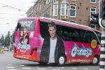 Amsterdam 15 augustus 2015
Tim Douwsma en  VajÃ¨n van den Bosch de hoofdrolspelers van de musical Grease staan groot op de bus