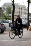 Amsterdam 20 juni 2015  
Trijntje Oosterhuis met zoontje op de fiets in Amsterdam. Trijntje gaat een huis binnen en ze geeft een toerist uitleg over hoe waar naartoe te lopen.