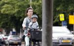 Amsterdam 16 juli 2023
Birgit Schuurman met zoontje op de fiets . Haar vriend Sander v Haarlem rijdt op scooter