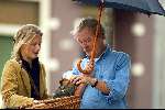 Amsterdam 30 augustus 2003
Midas Deckers onder paraplu met een vrouw met hond