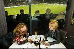 Eindhoven 31 Januari 2003
Restaurant Avangarde sinds januari 2003 een Michelin ster met op de achtergrond het PSV stadion.
Niet iedereen heeft oog voor het voetballen zoals te zien is aan beide dames die praten over het leven terwijl op de achtergrond de wedstrijd wordt gespeeld tussen PSV en vitesse.