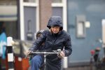Amsterdam 2 maart 2020
Tjitske Reidinga met zoon in de regen op de fiets.