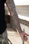 Amsterdam 15 april 2015
Dave en Dries Roelvink metselen een steen met daarop hun naam in de Westertoren. Dave heeft een tatoo van de westertoren op zijn arm staan.