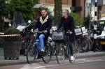 Amsterdam 28 april 2015
Rolf Snoeren (Viktor&Rolf) met zijn partner fietsend door amsterdam