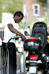 Amsterdam 11 augustus 2007
Regilio Tuur met zijn vespa scooter aan het tanken.