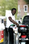 Amsterdam 11 augustus 2007
Regilio Tuur met zijn vespa scooter aan het tanken.
