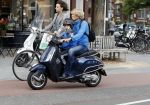 Amsterdam 2 september 2016 
Hans Jorritsma met zijn zoon op een vespa scooter