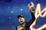 ABU DHABI, UNITED ARAB EMIRATES - DECEMBER 12: Race winner and 2021 F1 World Drivers Champion Max Verstappen of Netherlands and Red Bull Racing celebrates on the podium during the F1 Grand Prix of Abu Dhabi at Yas Marina Circuit on December 12, 2021 in Abu Dhabi, United Arab Emirates. (Photo by Mark Thompson/Getty Images)